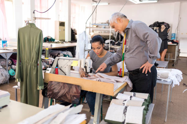 istock Manager and worker in chinese clothes factory 989794616