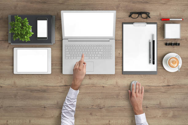istock Man working on a laptop knolling overhead view 989794788