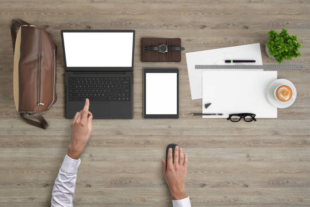 istock Man working on a laptop knolling overhead view 989794850