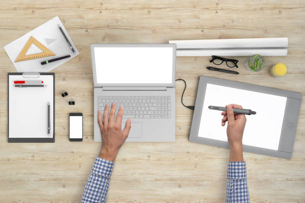 istock Architect designer working on office desk knolling overhead view 989794890