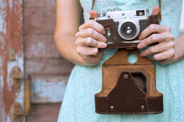 istock Girl with retro camera. Vintage 989800246