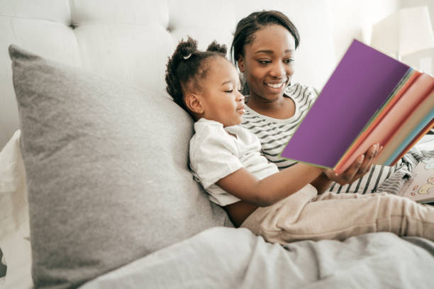 istock Encouraging a child to read 989800334