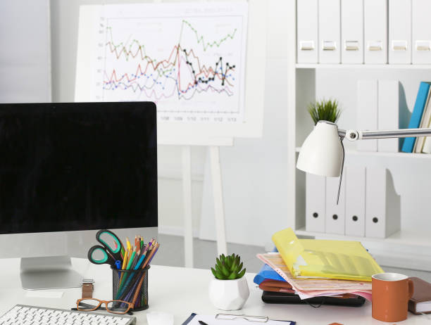 istock Workplace with notebook laptop Comfortable work table in office windows and city view 989810840