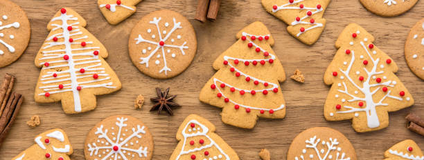 istock Christmas gingerbread cookies on wood background 989842560