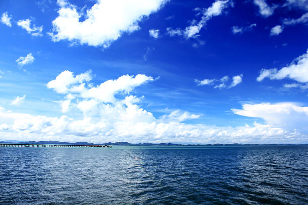 istock Mountains in the sea and clouds on the blue sky 989854458