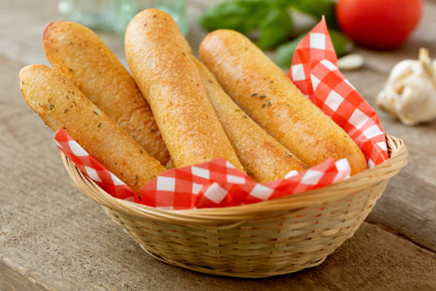 Bread Sticks Garlic Bread Sticks in Wicker Basket breadstick stock pictures, royalty-free photos & images