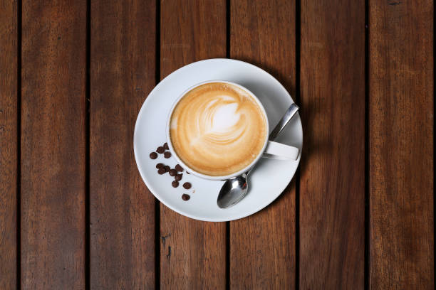 Coffee cup on the wooden desk concept