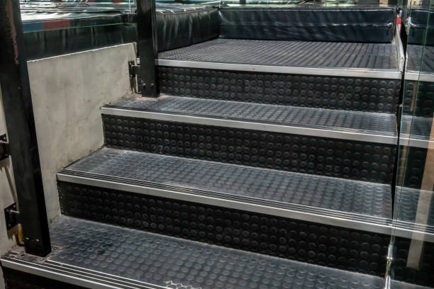 istock Non-slip stairs with dot pattern close up for background. A black rubber stairs. 989888356