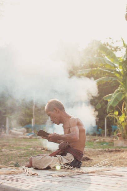 istock Uncle Asian fisherman with wicker tools. 989898268