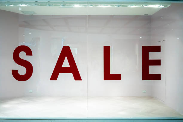istock Big sale sign on empty shop window in department store. 989928362