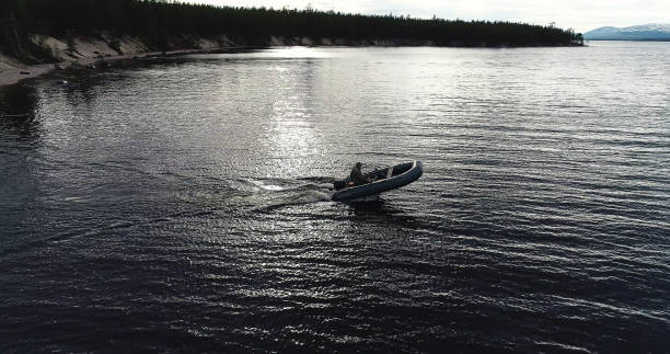 istock Tourist Driving and Maneuvering on Inflatable Boat 989957324