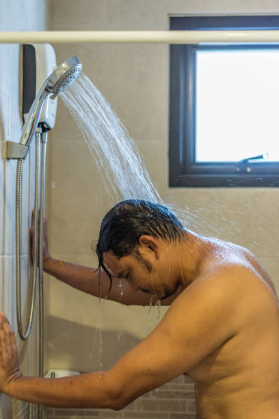 istock Asian man shower in bathroom for clean a body 989957544
