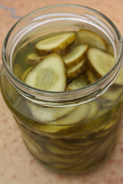 istock Large pickles in slices  Canned in glass jar 989961938