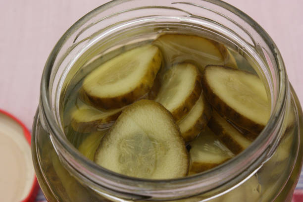 istock Large pickles in slices  Canned in glass jar 989962048