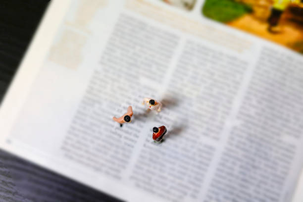 personal development and career growth or letting the past and be heading to the future concept in order to achieve set goals, grey background with miniature figurines watching at it