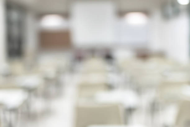 istock Blur classroom education background empty school class lecture room interior view with no teacher nor student 989987324
