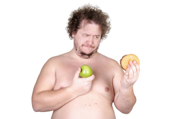 istock Diet and the problem of choice. Funny overweight man. White background. 989988432