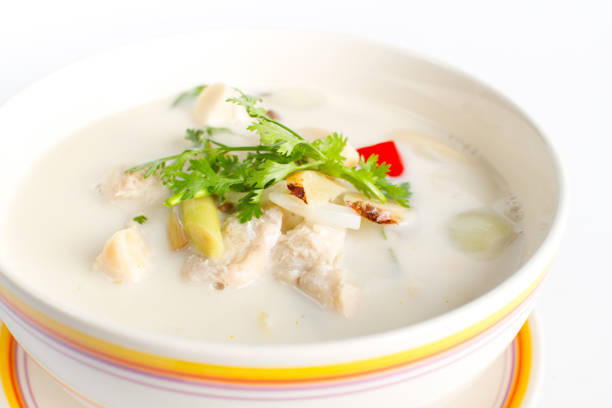 Traditional thai soup chicken in coconut milk on white background