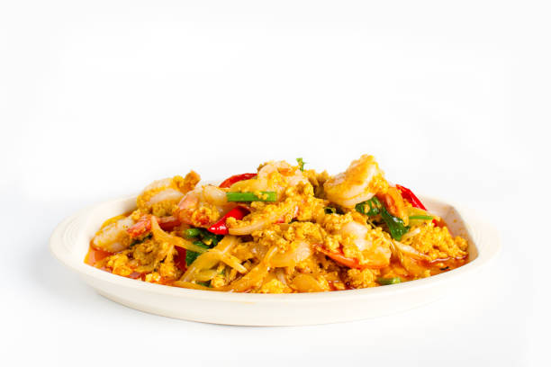 Stir fried shrimp in indian yellow powder with onion and egg on white background