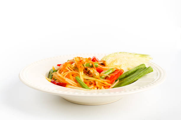 Traditional thai cuisine scipy green papaya salad on white background