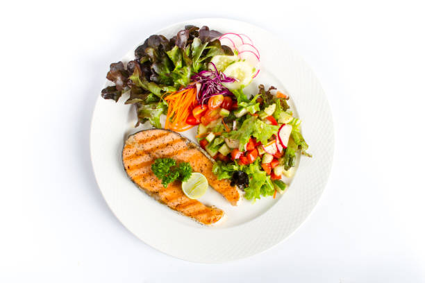 istock salmon steak grill with fresh salad and lemon onwhite background 990003010