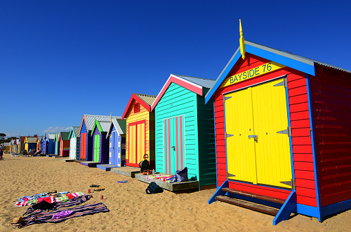 yellow beach huts on a bright sunny day