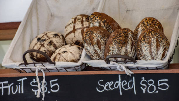 istock Freshly baked bread rolls on display outside a specialist bakery in Sydney. 990024712
