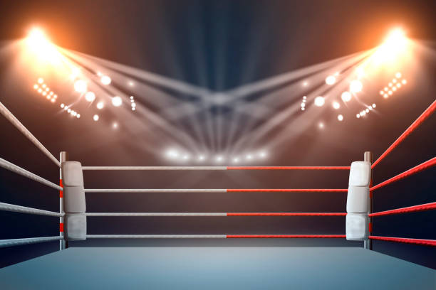 istock boxing ring with illumination by spotlights. digital effect. 990033044