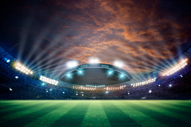 istock lights at night and football stadium 3d rendering. Mixed photos 990033174