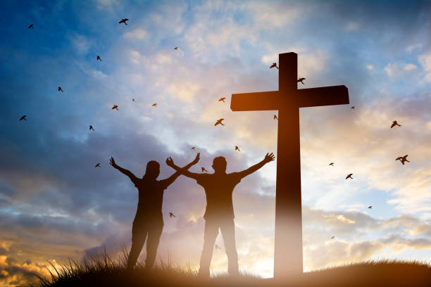 Family worship concept: a family at the Cross of Jesus. Family worship concept: a family at the Cross of Jesus. easter sunday photos stock pictures, royalty-free photos & images