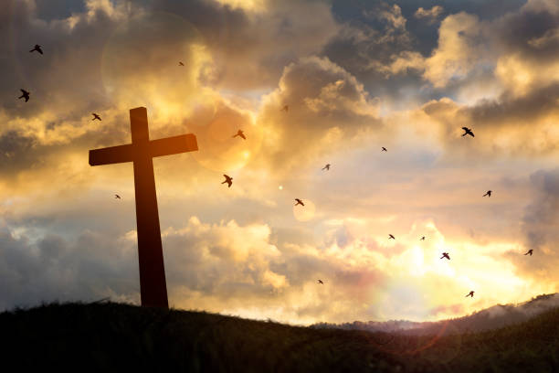 istock The cross with sunset in the sky background 990033436