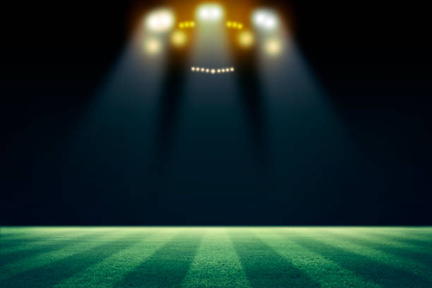 istock lights at night and football stadium 3d rendering. Mixed photos 990053068