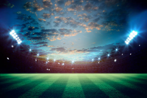 istock lights at night and football stadium 3d rendering. Mixed photos 990053334