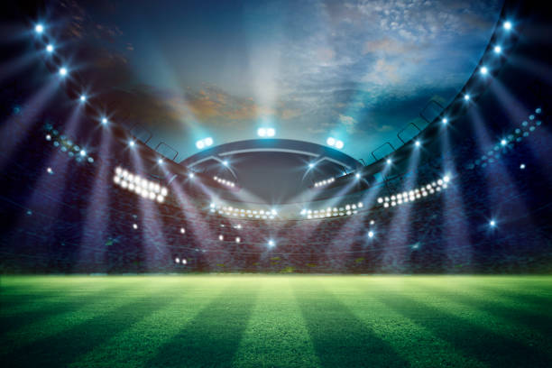 istock lights at night and football stadium 3d rendering. Mixed photos 990055614