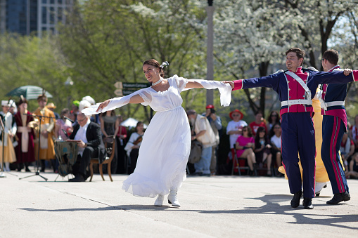 Chicago, Illinois, USA - May 05, 2018 Members of Polonia, polish folk song and dance ensemble, wearing traditional clothing, perform polish traditional dancing at the Grant Park, after the Polish Constitution Day Parade.