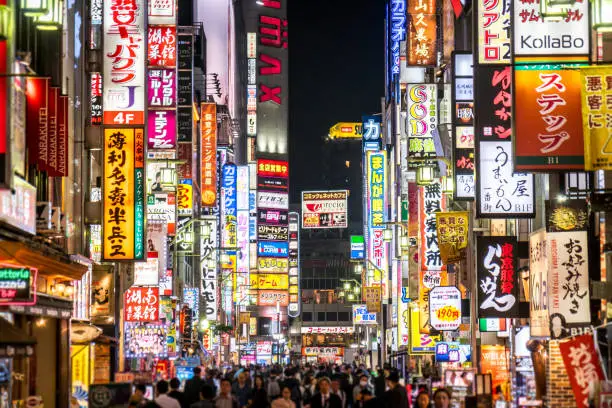 Crowded streets in Shinjuku at night.