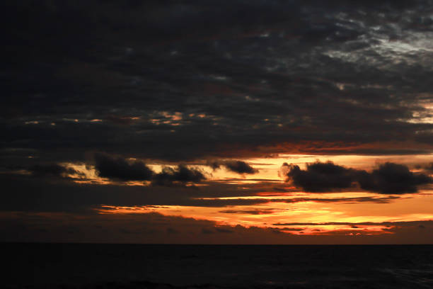 istock Orange light of the sunset is falling in the sea. 990078014