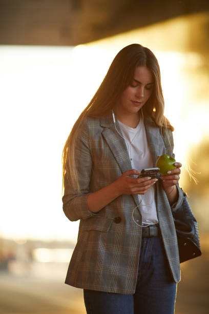 istock Pretty girl talk on her phone with sunset background 990083390