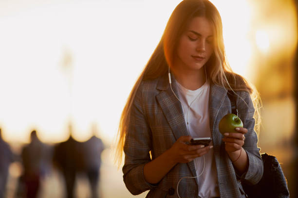 istock Pretty girl talk on her phone with sunset background 990083414