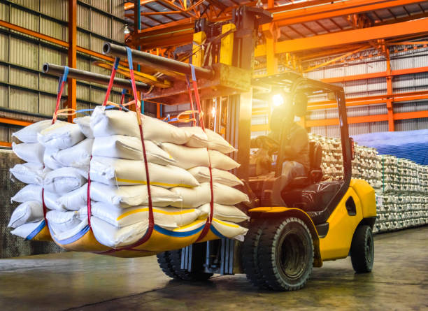 Forklift handling sugar bags for stuffing into container for export. Distribution, Logistics Import Export, Warehouse operation, Trading, Shipment, Delivery concept. raw food stock pictures, royalty-free photos & images