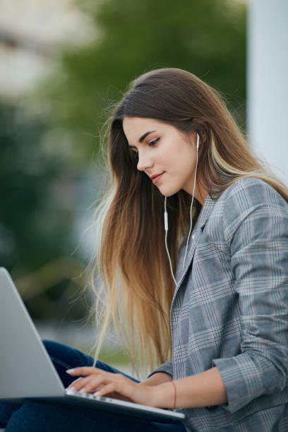 istock Pretty girl sit with her laptop and stydy. White background 990083802