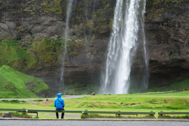 istock Tourist near a Seljalandsfoss waterfall in Iceland 990117238