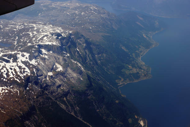 view from the plane to the mountain and the sea in norway - mountain range earth sky airplane imagens e fotografias de stock