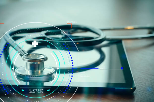 istock Studio macro of a stethoscope and digital tablet with shallow DOF evenly matched abstract on wood table background copy space 990129904