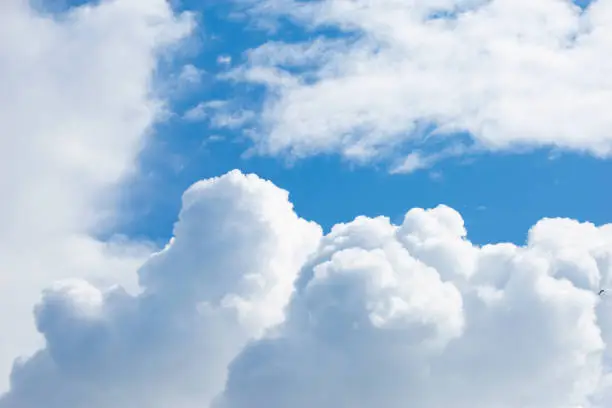 White cumulus clouds against the blue sky. Can be used as a background or wallpaper for your desktop. There is space for text.