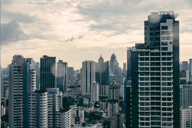 istock Rain over Bangkok: Cityscape behind the window glass with rain drops. 990135204
