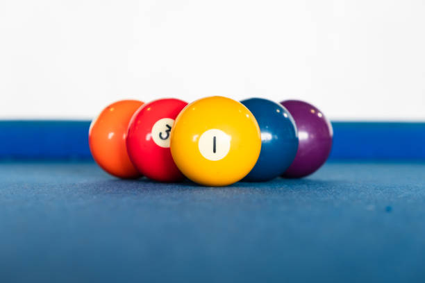 istock diamond shape of 9-ball pool balls placed in rack position on blue felt table 990177732