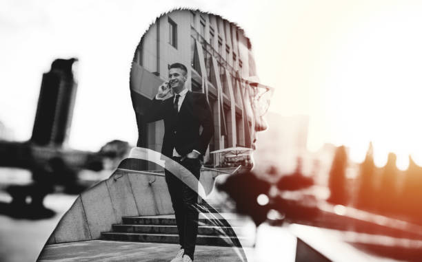 istock Handsome business man in full suit talking on phone 990193072