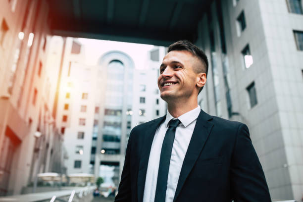 istock Smiling Business man on urban background 990195174