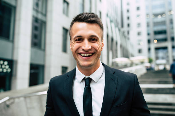 istock Smiling Business man on urban background 990197396